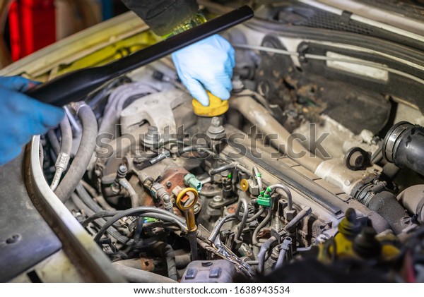 dismantled car engine in a\
car workshop
