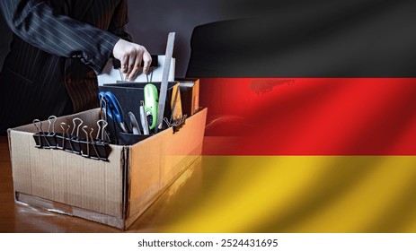 Dismissal people in Germany. Hands fired man near flag. Dismissal box with symbol Germany. Man collects personal belongings after dismissal. German unemployed manager with box. Problem worker layoffs - Powered by Shutterstock