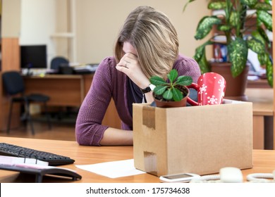 Dismissal at work, weeping employee with things to take away