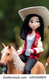 Disney princess doll Mulan walking on a horse
