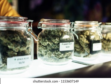 A dispensary worker vending jars of cannabis.