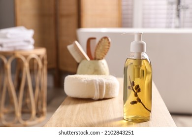 Dispenser with liquid soap on wooden table in bathroom, space for text