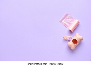 Dispenser With Pet Waste Bags On Lilac Background