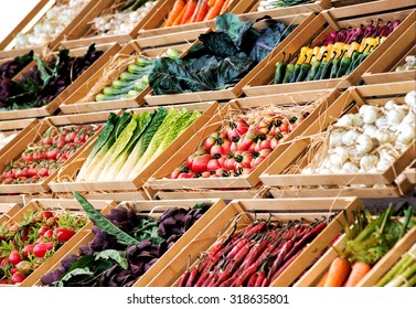 Display Of Assorted Farm Fresh Vegetables On A Market Stall Or In A Store Neatly Arranged In Rows In Wooden Boxes