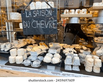 Display of assorted traditional French goat cheeses in a shop with French letters means "Goat cheese season"  - Powered by Shutterstock