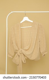 Display Of Brown Outfit On Clothing Rack In Fashion Studio.