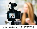 Display of camera recording video blog for blonde beauty blogger woman with make-up at home studio. Influencer vlogger girl live streaming cosmetics masterclass. Online learning and marketing concept.