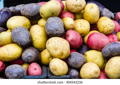 Display Of Red, White And Blue Potatoes At The Market