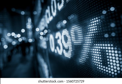 Display Stock Market Numbers With Defocused Street Lights Background