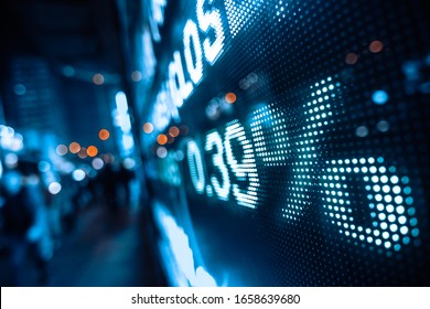 Display stock market numbers with defocused street lights background