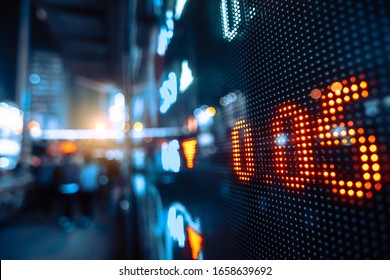 Display Stock Market Numbers With Defocused Street Lights Background