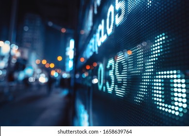 Display Stock Market Numbers With Defocused Street Lights Background