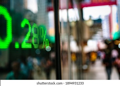 Display Of Stock Market Quotes With City Lights Reflect On Glass, Screen Board On The Street