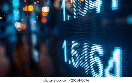 Display of Stock market quotes with city lights reflect on glass, small focus line