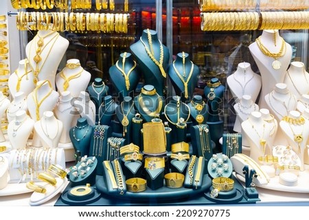Display window with expencive gold jewelry. Bracelets, necklaces and chainlets for sale.
