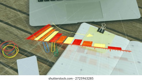 Displaying open lined notebook with translucent colored ruler overlay on wooden desk, laptop edge. Journal, diagonal, multicolor, woodgrain, clips, bands, stationery