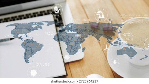 Displaying translucent world map overlay showing CO2 icons and numeric data on desk with laptop. Emissions, globe, analytics, dashboard, workspace, modern, climate