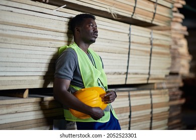 Displeased African American Worker Thinking Of Something While Working At Lumber Distribution Warehouse.