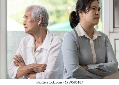 Displeased Asian Daughter Sitting Back To Back After Quarrel,argue Feel Offended At Home,angry Upset Elderly Mother With Crossed Arms,relationship Difficulties,conflict,family Crisis,lifestyle Problem