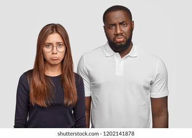 Displeased Classmates Have Miserable Facial Expressions, Purse Lips With Negative Emotions, Feel Dejected, Have Problems With Studying, Cant Find Common Language, Isolated On White Studio Wall