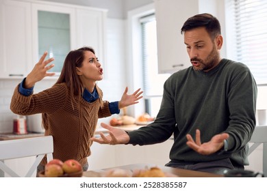 Displeased couple arguing about something at home. - Powered by Shutterstock