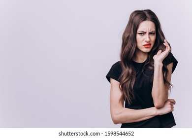 Displeased Cute Brunette Girl Showing Incomprehension And Disgust