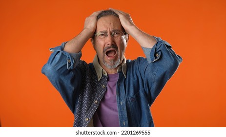 Displeased Irritated Sad Angry Elderly Bearded Man 50s 60s Cover Ears Do Not Want To Listen Scream Isolated On Solid Plain Orange Background Studio Portrait