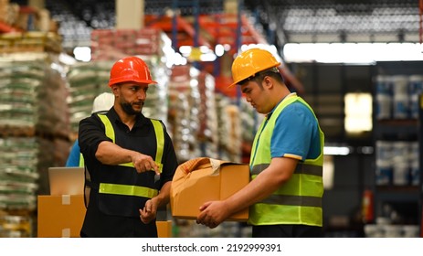 Displeased Male Manager Scolding Young Frustrated Intern About Bad Work Results, Damaged Cardboard Box. Stress At Work Concept