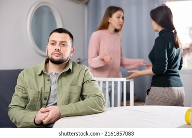 Displeased Man Waiting For Two Women Relatives To Calm Down And Stop Quarreling At Home