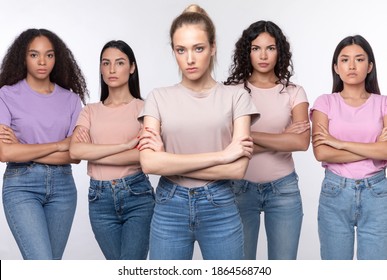 Displeased Mixed Women Standing Crossing Hands Disapproving Something Posing Looking At Camera With Serious Expression Over White Studio Background. We Don't Accept It Concept