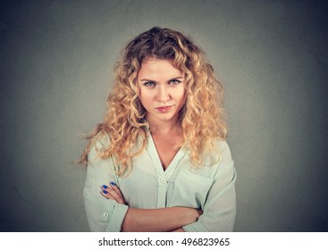 Displeased pissed off angry grumpy pessimistic woman with bad attitude, arms crossed looking at you Negative human emotion facial expression feeling