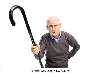 Displeased senior holding a black cane and scolding someone towards the camera isolated on white background