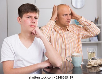 Displeased teenage son dont speaking after discord with father at home