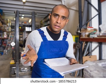 Displeased Warehouse Manager With Documents After An Audit In A Hardware Store