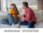 Displeased woman manipulator ignoring husband wanting to talk. Frustrated wife abuser creates toxic atmosphere in family couple. Domestic emotional stress, misunderstanding, relationship problems.
