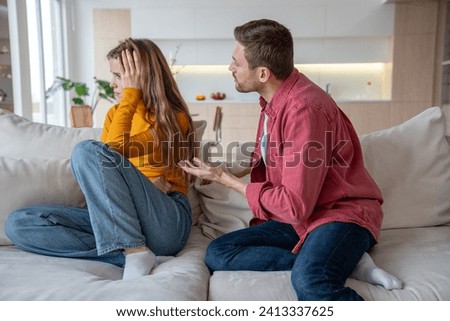 Displeased woman manipulator ignoring husband wanting to talk. Frustrated wife abuser creates toxic atmosphere in family couple. Domestic emotional stress, misunderstanding, relationship problems.