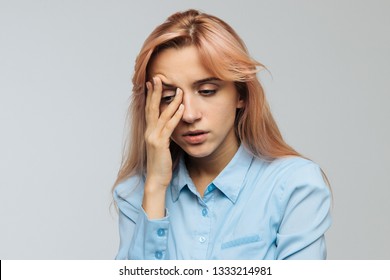 Displeased woman nearly falling asleep at work, hold her head with hand.Sleepy student spending time in university, feels lack of energy. Sleep deprivation, insomnia, apathy, weariness concept