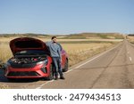 Displeased young adult man breaks down car in the middle of trip on the road calls tow truck to come repair car, roadside assistance, broken down car tired man