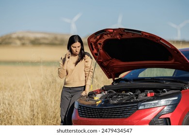 Displeased young adult woman breaks down car in the middle of trip on the road calls tow truck to come repair car, roadside assistance, broken down car tired women - Powered by Shutterstock