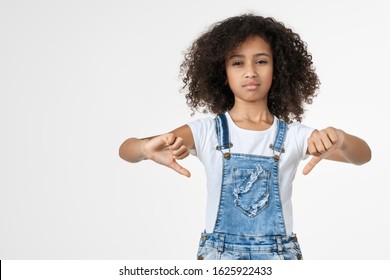 Displeased Young African Girl Kid Showing Thumbs Down Isolated Over White Background