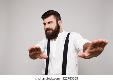 Displeased Young Handsome Man Refuse Over White Background.