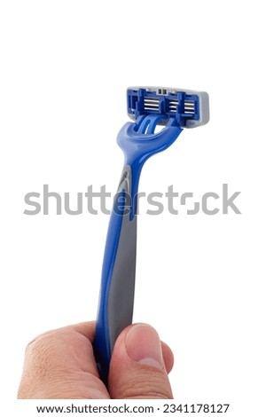 Disposable blue razor in men hand isolated on white background. Сlose-up. With clipping path