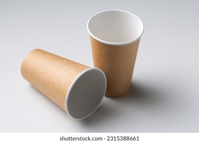 Disposable cardboard biodegradable cups on a white table, gray background. - Powered by Shutterstock