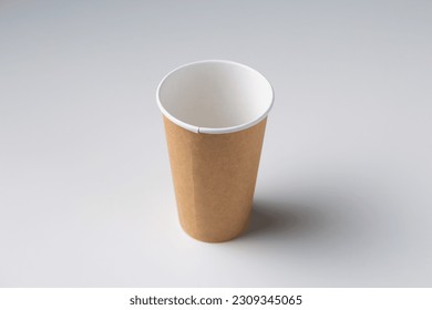 Disposable cardboard biodegradable glass on a white table, gray background. - Powered by Shutterstock