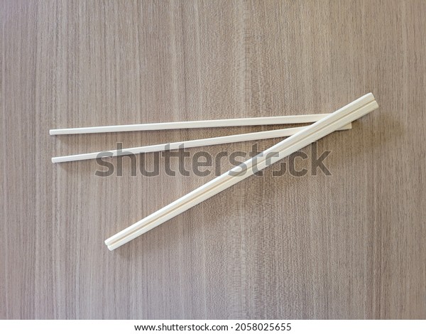 Disposable chopsticks, in the\
form of a piece of light wood that is split in the middle but not\
cut until it breaks.  Users can split themselves into a pair of\
chopsticks.