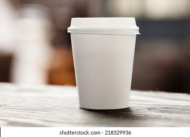 Disposable coffee cup on table - Powered by Shutterstock