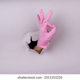 Disposable colored latex gloves. Hand in gloves. Medicine. Sterility. - Shutterstock ID 2311315235