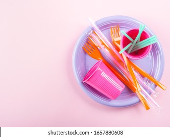 Disposable Colorful Plastic Dishes, Cutlery, Straws And Glasses. Creative Flat Lay