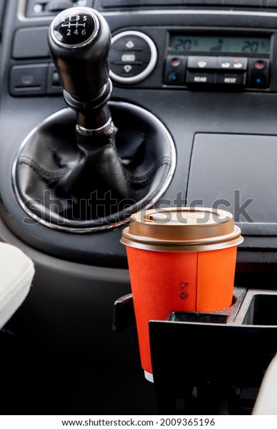 A disposable cup\
of coffee in the car, to keep you concentrated while driving.\
Driving assistance, caffeine 