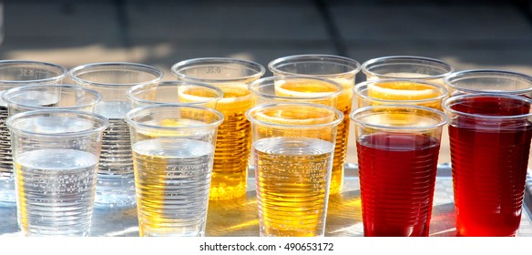 Disposable Cups With Non Alcoholic Beverages On An Outdoor  Party
